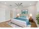 Bright bedroom with a ceiling fan, ensuite bathroom, and hardwood flooring at 117 E Concord St # 8, Orlando, FL 32801