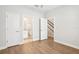Clean bedroom with wood flooring, with access to the bathroom and staircase at 117 E Concord St # 8, Orlando, FL 32801