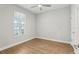 A bedroom with wood floors, a window, and a door leading to the closet at 117 E Concord St # 8, Orlando, FL 32801