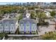 Charming townhome featuring a light gray exterior, teal accents, and a welcoming front porch perfect for relaxing at 117 E Concord St # 8, Orlando, FL 32801