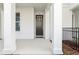 Home featuring a modern black front door with sidelight, white columns, and a small front porch at 117 E Concord St # 8, Orlando, FL 32801