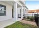 Charming front porch with white columns, brick walkway, and tidy landscaping at 117 E Concord St # 8, Orlando, FL 32801