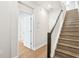 Hallway with hardwood floors, stairs, and white doors to other rooms at 117 E Concord St # 8, Orlando, FL 32801