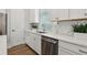 Bright kitchen featuring white cabinets, stainless steel appliances and stone countertops at 117 E Concord St # 8, Orlando, FL 32801
