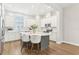 Contemporary kitchen with a gray island, white cabinets, stainless steel appliances, and a view to the window at 117 E Concord St # 8, Orlando, FL 32801