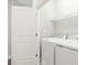 Bright laundry room features a white washer and dryer, complemented by a wire shelf for storage at 117 E Concord St # 8, Orlando, FL 32801