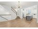Open concept living room with wood floors, leading to a staircase and an island kitchen at 117 E Concord St # 8, Orlando, FL 32801