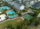 Aerial view of community pool, basketball court, townhomes, and landscaped green spaces at 13041 Gabor Ave, Orlando, FL 32827
