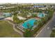 Aerial view of the community featuring multiple pools, lounge areas, and palm tree landscaping at 13041 Gabor Ave, Orlando, FL 32827