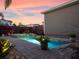 Relaxing backyard oasis with a modern pool, spa and professionally landscaped yard at 13041 Gabor Ave, Orlando, FL 32827