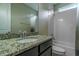 Bathroom featuring vanity with granite counters, large mirror, shower and tub combination at 13041 Gabor Ave, Orlando, FL 32827
