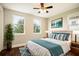 Bedroom with hardwood floors, king bed, side tables, and a large potted plant at 13041 Gabor Ave, Orlando, FL 32827