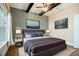 Modern primary bedroom featuring a bed with a gray headboard, two lamps, and art on the walls at 13041 Gabor Ave, Orlando, FL 32827