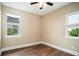 Shot of a bedroom with wood floors and many windows at 13041 Gabor Ave, Orlando, FL 32827