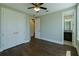 Bedroom featuring wood floors, a ceiling fan, a bathroom, and a walk in closet at 13041 Gabor Ave, Orlando, FL 32827