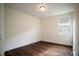 Unfurnished bedroom with wood floors, white walls, trim, and a bright window at 13041 Gabor Ave, Orlando, FL 32827