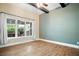 Bedroom with a large window, hardwood floors, modern ceiling fan, and high ceilings at 13041 Gabor Ave, Orlando, FL 32827