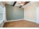 Bedroom with a large window, hardwood floors, modern ceiling fan, and high ceilings at 13041 Gabor Ave, Orlando, FL 32827