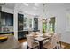 Bright dining room features a stylish chandelier and views of the lake at 13041 Gabor Ave, Orlando, FL 32827