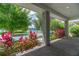 Inviting front porch with brick columns, beautiful plants, and a serene water view at 13041 Gabor Ave, Orlando, FL 32827