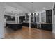 Modern kitchen features dark cabinets, stainless steel appliances, granite countertops, and hardwood floors at 13041 Gabor Ave, Orlando, FL 32827