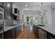 Gourmet kitchen features dark wood cabinets, stainless steel appliances, and a spacious island at 13041 Gabor Ave, Orlando, FL 32827