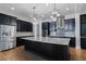 Modern kitchen features a large center island, stainless steel appliances, and stylish lighting at 13041 Gabor Ave, Orlando, FL 32827