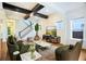 Bright living room with exposed wood beam ceiling and modern furnishings overlooking the stairway at 13041 Gabor Ave, Orlando, FL 32827