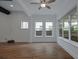 Bright living room with hardwood floors, large windows, and a modern ceiling fan at 13041 Gabor Ave, Orlando, FL 32827