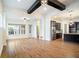 A spacious living room featuring hardwood floors, exposed beams, and an open-concept design at 13041 Gabor Ave, Orlando, FL 32827