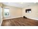 Living room featuring wood flooring, natural light and an entertainment center at 13041 Gabor Ave, Orlando, FL 32827