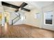 Bright, open-concept living area with hardwood floors and modern ceiling beams at 13041 Gabor Ave, Orlando, FL 32827