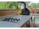 Well-equipped outdoor kitchen with built-in grill and countertops near the pool at 13041 Gabor Ave, Orlando, FL 32827