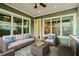 Comfortable outdoor living space on a covered brick patio featuring a ceiling fan and stylish furniture at 13041 Gabor Ave, Orlando, FL 32827