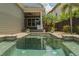 Inviting backyard pool and spa with lush landscaping and covered patio at 13041 Gabor Ave, Orlando, FL 32827