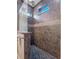 Walk-in shower with decorative tile and pebble floor at 13041 Gabor Ave, Orlando, FL 32827