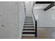 View of staircase with decorative dark wood treads and white risers leading to the second floor at 13041 Gabor Ave, Orlando, FL 32827
