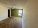 An empty bedroom with window, fan and green accent wall, ready for renovations at 1322 Aguacate Ct, Orlando, FL 32837