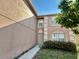 Close up of home's exterior with neutral color scheme, showing front door and landscape at 1322 Aguacate Ct, Orlando, FL 32837