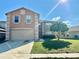 Two-story home featuring a two-car garage and a well-maintained front yard with a mature tree at 1322 Aguacate Ct, Orlando, FL 32837