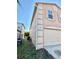 Home exterior featuring 2 car garage and neutral color palette at 1322 Aguacate Ct, Orlando, FL 32837