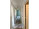 Bright hallway featuring white trim, doors, and walls and neutral colored flooring at 1322 Aguacate Ct, Orlando, FL 32837