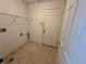 Laundry room with a storage shelf and white door ready for customization at 1322 Aguacate Ct, Orlando, FL 32837