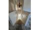 View looking down the interior staircase with decorative chandelier in an unfinished home at 1322 Aguacate Ct, Orlando, FL 32837