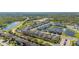 Expansive aerial view of a community with lush landscaping, a pond, and modern homes at 14321 Wabasso Loop, Winter Garden, FL 34787