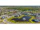 High-angle image of neighborhood with pond, lush landscaping, and modern homes at 14321 Wabasso Loop, Winter Garden, FL 34787