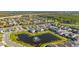 Beautiful aerial view of a new residential community with a scenic pond and fountain at 14321 Wabasso Loop, Winter Garden, FL 34787
