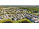 Overhead view of community featuring manicured lawns, ponds, and modern two-story homes at 14321 Wabasso Loop, Winter Garden, FL 34787