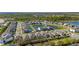 Picturesque aerial view of a neighborhood with homes surrounding a pond, showcasing a well-planned community at 14321 Wabasso Loop, Winter Garden, FL 34787