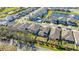 Aerial view showcases the property's backyard, neighborhood, and nearby pond at 14321 Wabasso Loop, Winter Garden, FL 34787